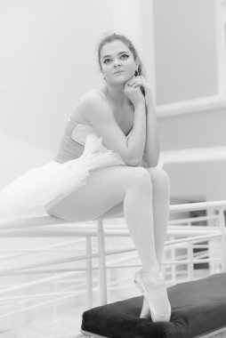 Black and white photo of flexible slender young girl ballerina. BW