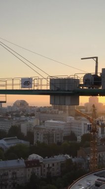 Dikey video - Şafakta şehirde inşaat vinci. Kyiv, Ukrayna.