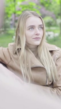 Parktaki genç, sıska bir kızın dikey videosu..