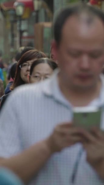 A crowd of people on the streets of the city. Beijing. China. Vertical video — Stock Video