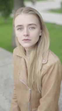 Parktaki genç, sıska bir kızın dikey videosu..