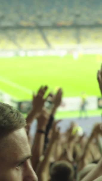 Fans in the stadium during the game. Vertical video — Stock Video