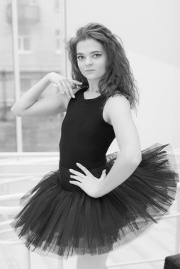Black and white photo of flexible slender young girl ballerina. BW