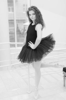 Black and white photo of flexible slender young girl ballerina. BW