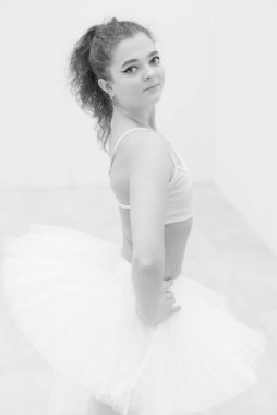 Black and white photo of flexible slender young girl ballerina. BW