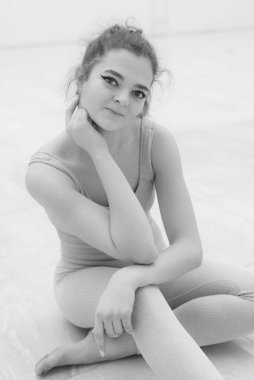 Black and white photo of flexible slender young girl ballerina. BW