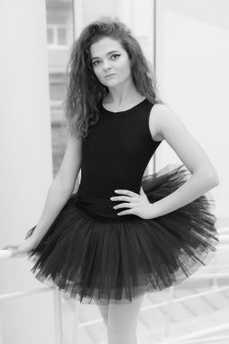Black and white photo of flexible slender young girl ballerina. BW