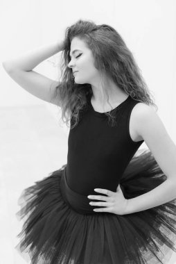 Black and white photo of flexible slender young girl ballerina. BW