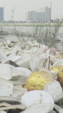 Deniz kıyısındaki dikey videoda plastik çöpler