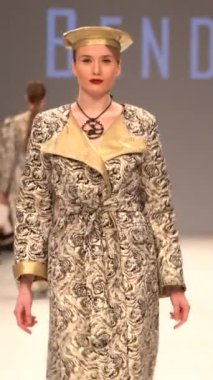 Woman model on the catwalk during a fashion show Vertical video