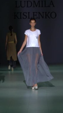 Woman model on the catwalk during a fashion show Vertical video