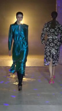 Woman model on the catwalk during a fashion show Vertical video