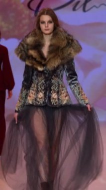 Woman model on the catwalk during a fashion show Vertical video