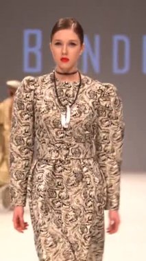 Woman model on the catwalk during a fashion show Vertical video