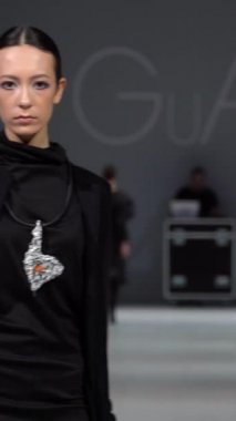 Woman model on the catwalk during a fashion show Vertical video