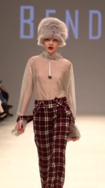 Woman model on the catwalk during a fashion show Vertical video
