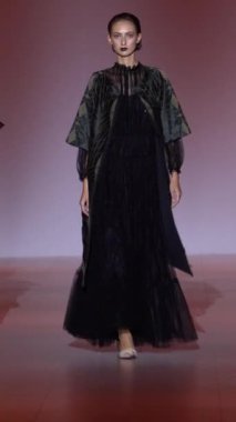 Woman model on the catwalk during a fashion show Vertical video