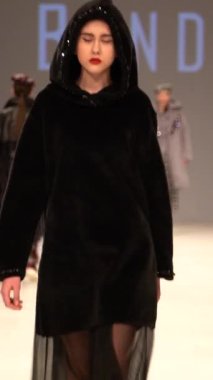 Woman model on the catwalk during a fashion show Vertical video
