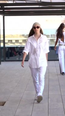 Woman model on the catwalk during a fashion show Vertical video