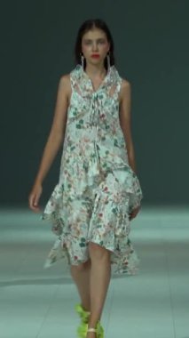 Woman model on the catwalk during a fashion show Vertical video