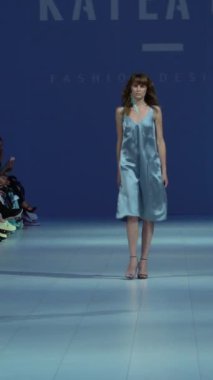 Woman model on the catwalk during a fashion show Vertical video