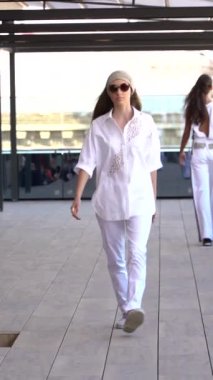 Woman model on the catwalk during a fashion show Vertical video
