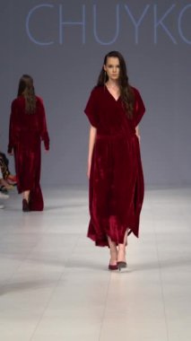 Woman model on the catwalk during a fashion show Vertical video