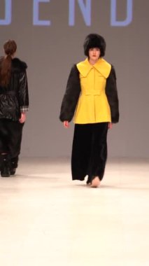 Woman model on the catwalk during a fashion show Vertical video