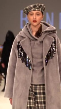 Woman model on the catwalk during a fashion show Vertical video