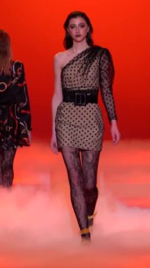 Woman model on the catwalk during a fashion show Vertical video