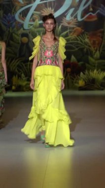 Woman model on the catwalk during a fashion show Vertical video