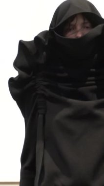 Woman model on the catwalk during a fashion show Vertical video