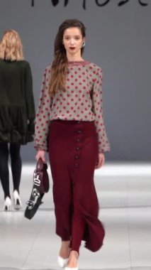 Woman model on the catwalk during a fashion show Vertical video