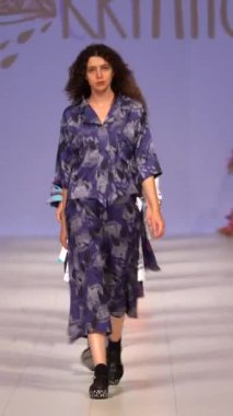 Woman model on the catwalk during a fashion show Vertical video