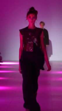 Woman model on the catwalk during a fashion show Vertical video