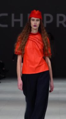 Woman model on the catwalk during a fashion show Vertical video