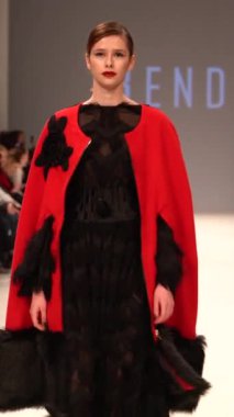Woman model on the catwalk during a fashion show Vertical video