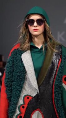 Woman model on the catwalk during a fashion show Vertical video