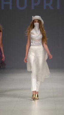 Woman model on the catwalk during a fashion show Vertical video