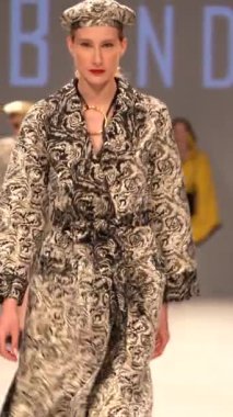 Woman model on the catwalk during a fashion show Vertical video