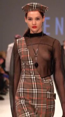 Woman model on the catwalk during a fashion show Vertical video
