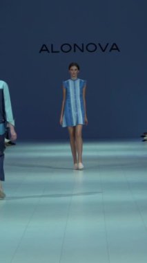 Woman model on the catwalk during a fashion show Vertical video