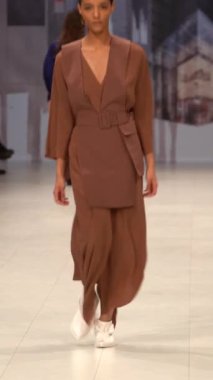 Woman model on the catwalk during a fashion show Vertical video