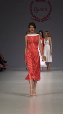 Woman model on the catwalk during a fashion show Vertical video