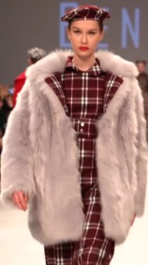 Woman model on the catwalk during a fashion show Vertical video
