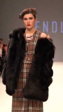 Woman model on the catwalk during a fashion show Vertical video