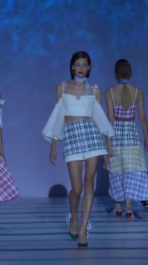 Woman model on the catwalk during a fashion show Vertical video