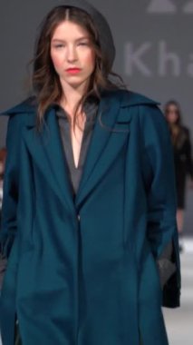 Woman model on the catwalk during a fashion show Vertical video