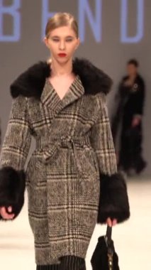 Woman model on the catwalk during a fashion show Vertical video