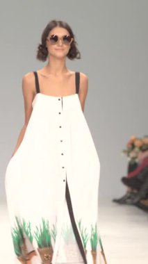 Woman model on the catwalk during a fashion show Vertical video